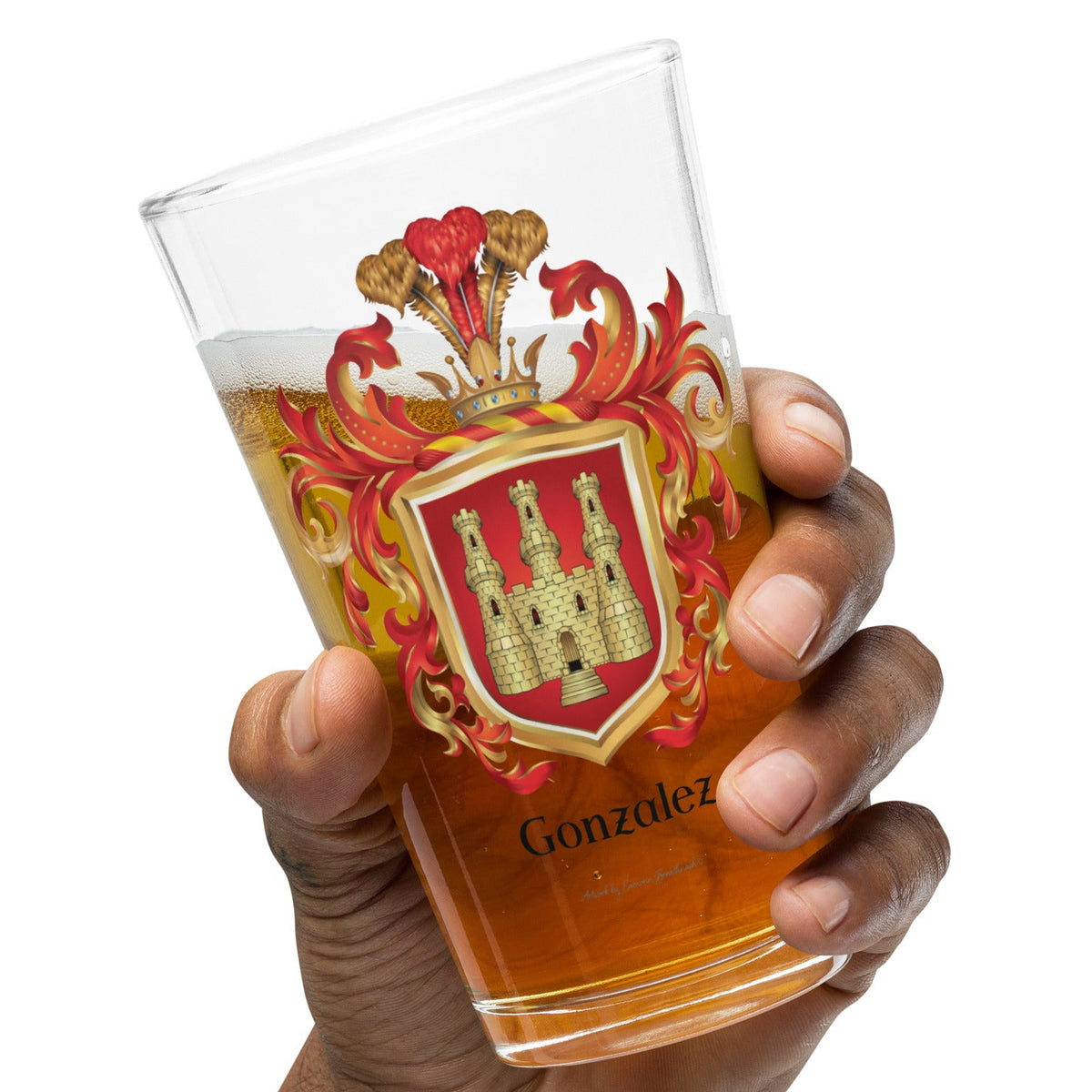 Hand holding a pint glass of beer with a Gonzalez Family Crest coat of arms design on a white background