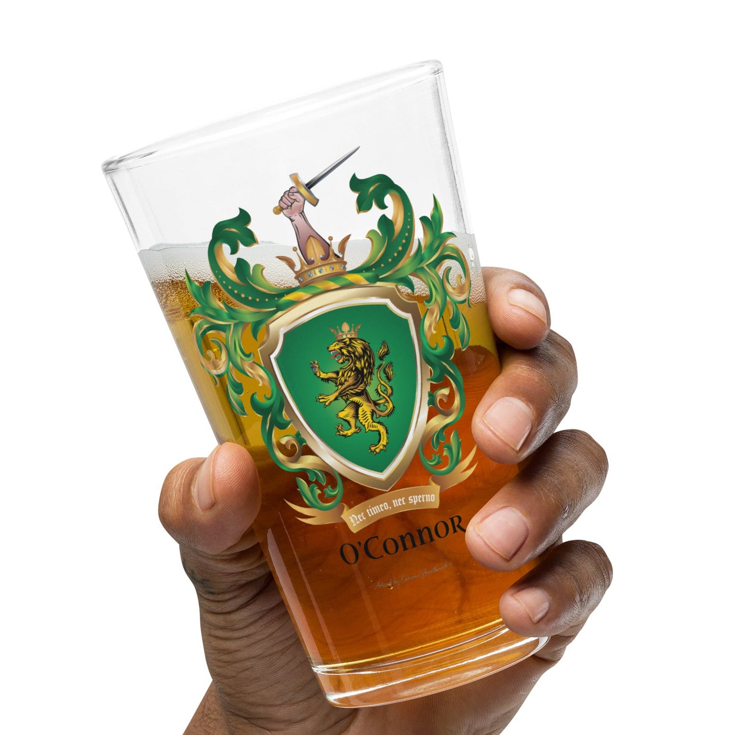 A hand holding a pint glass of beer with O'Connor-family-crest with a lion on a green shield on the front