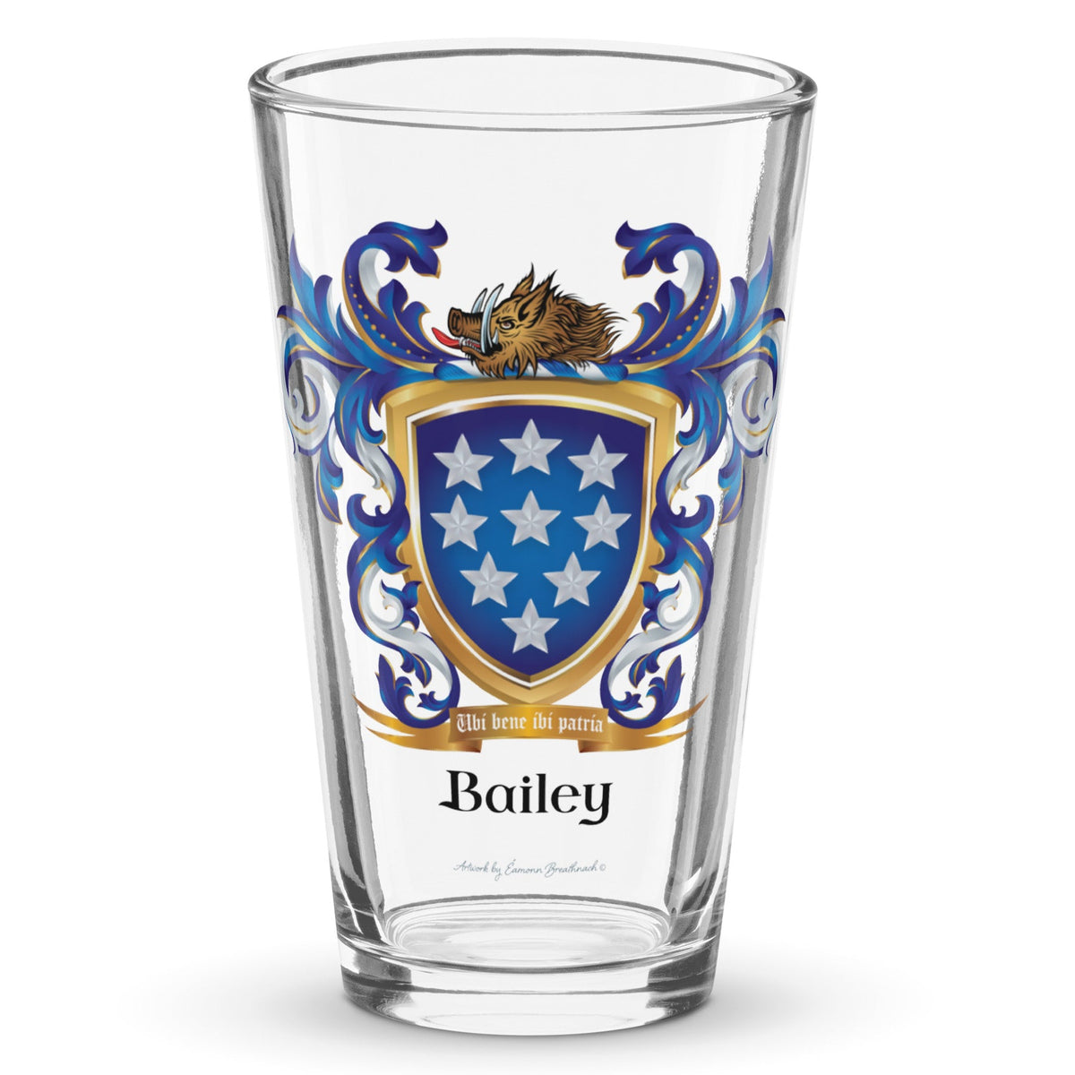 A clear classic pint beer glass on a white background, printed with the Bailey Family Crest featuring a blue shield with 9 white stars and a boar’s head on the crest of the shield.