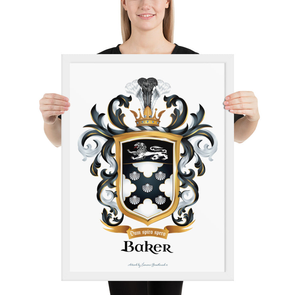 A woman stand in white space holding a white framed print of the Baker Family Crest featuring 5 shells, and a white lion.