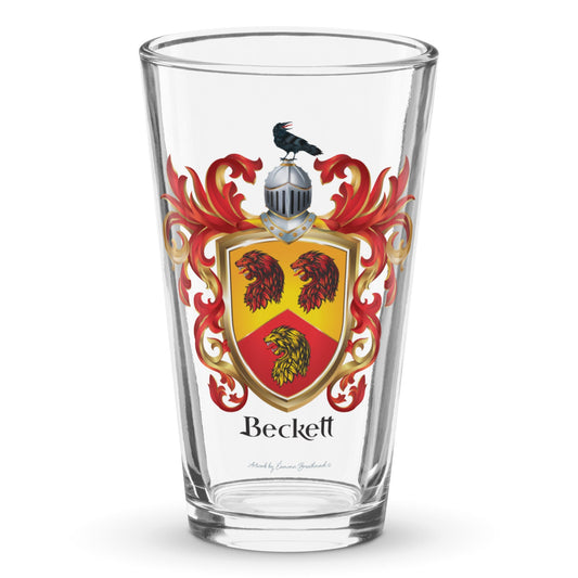 A classic clear pint beer glass with Beckett Family Crest showing 3 lion heads and a raven on a helmet