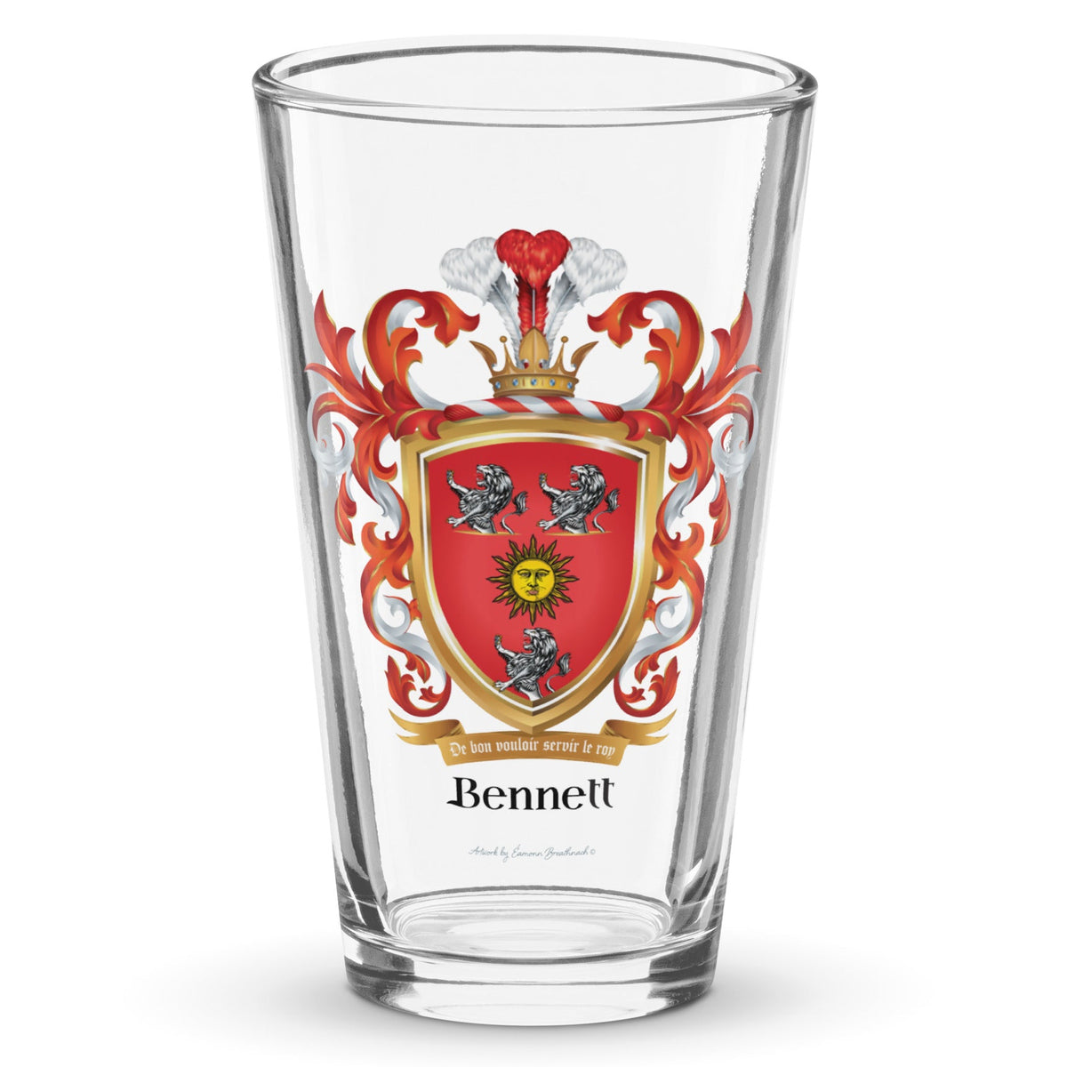 A clear classic pint beer glass on a white background, printed with the Bennett Family Crest featuring 3 white lions and a golden sun.
