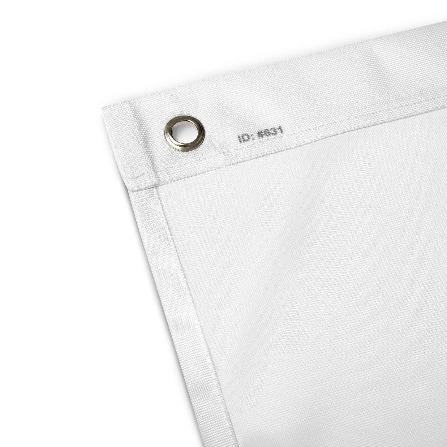 Close-up of a white fabric with a metal grommet and label on a white background