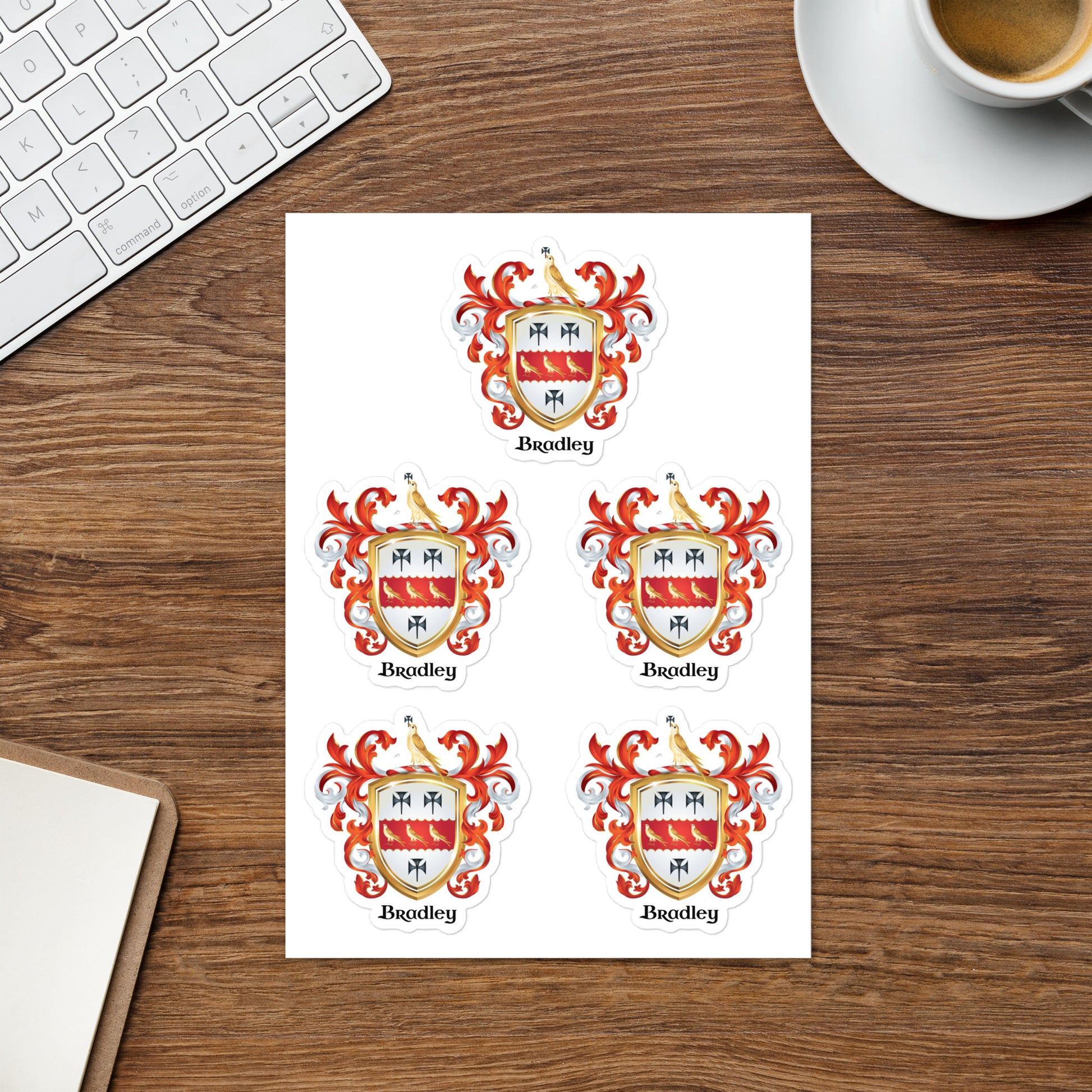 Bradley family crest stickers on a desk with keyboard and a cup of coffee