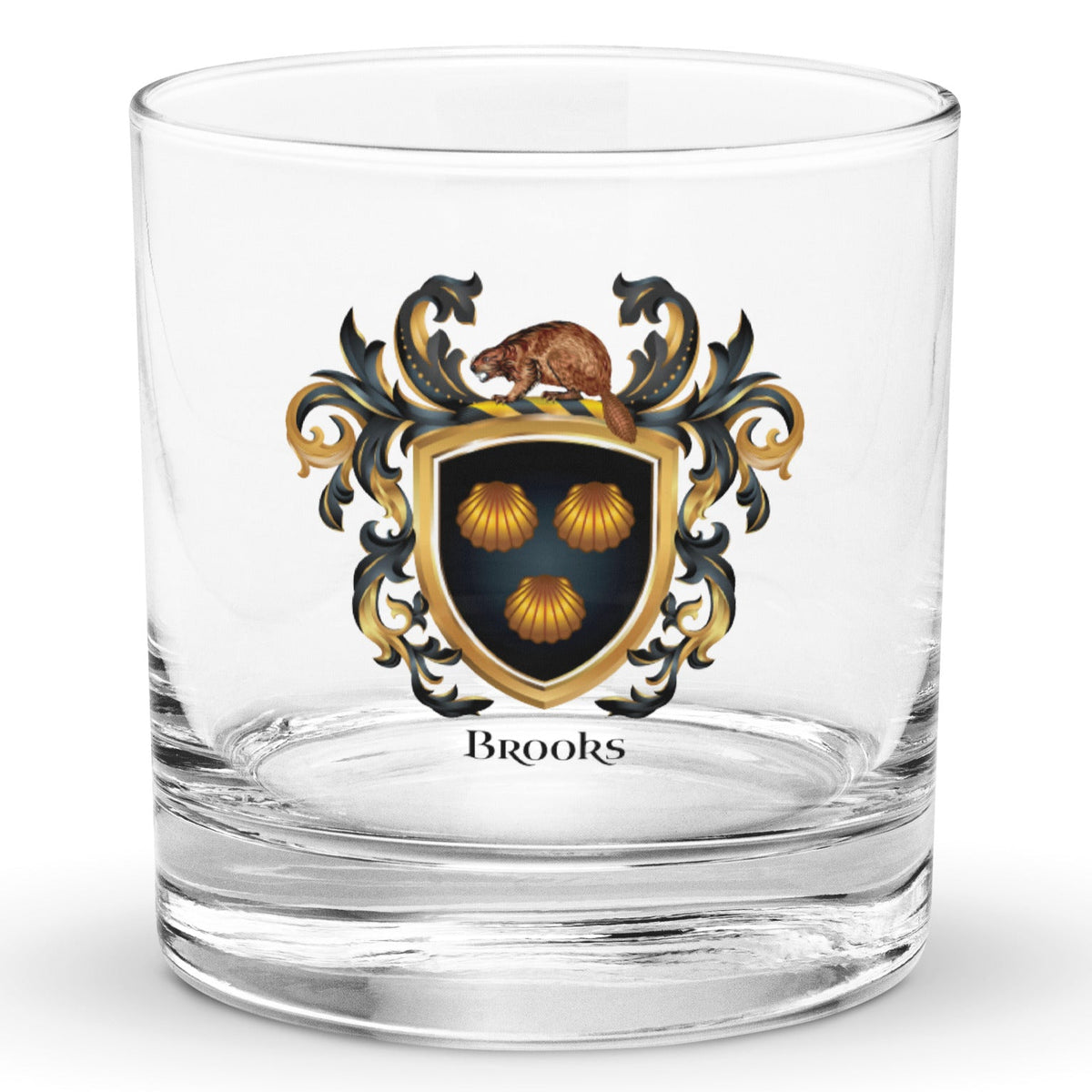 A clear, classic rocks glass on a white background, printed with the Brooks Family Crest featuring 3 clam shells on a black shield with a beaver on the crest of the shield.