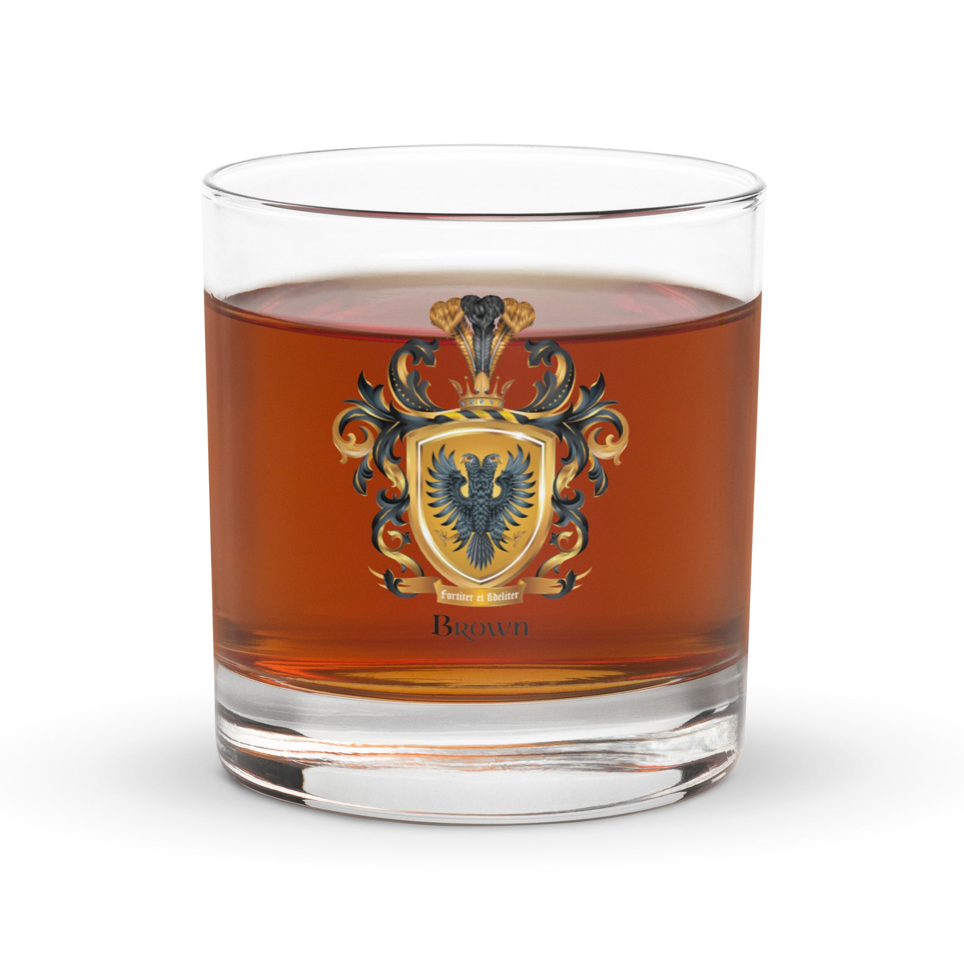 Glass with a Brown Family coat of arms design featuring a two-headed eagle filled with a double shot of whiskey on a white background