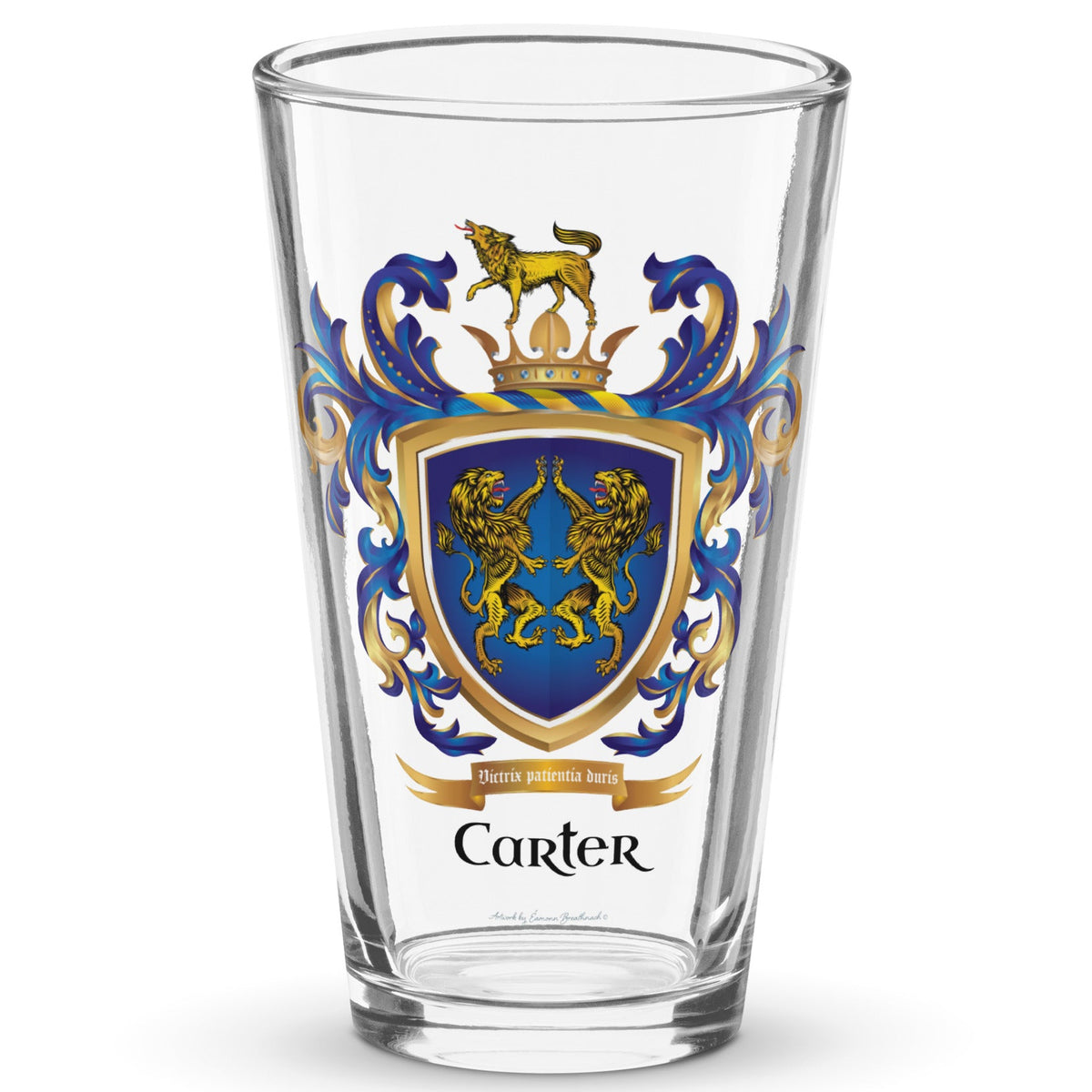 A clear classic pint beer glass on a white background printed with the Carter Family Crest featuring 2 lions on a blue shield and a wolf on a crown on the crest above the shield.