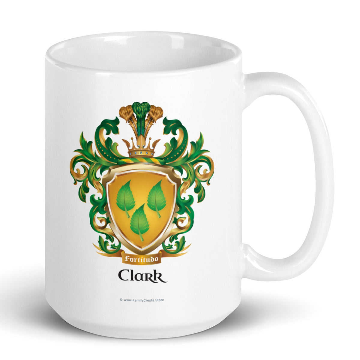 A white mug with the Clark Family Crest which has 3 green nettle leaves on a gold shield, printed on the front of the mug.