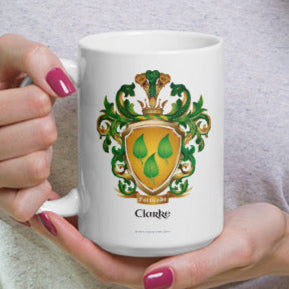 A white mug with the Clarke Family Crest held in two hands