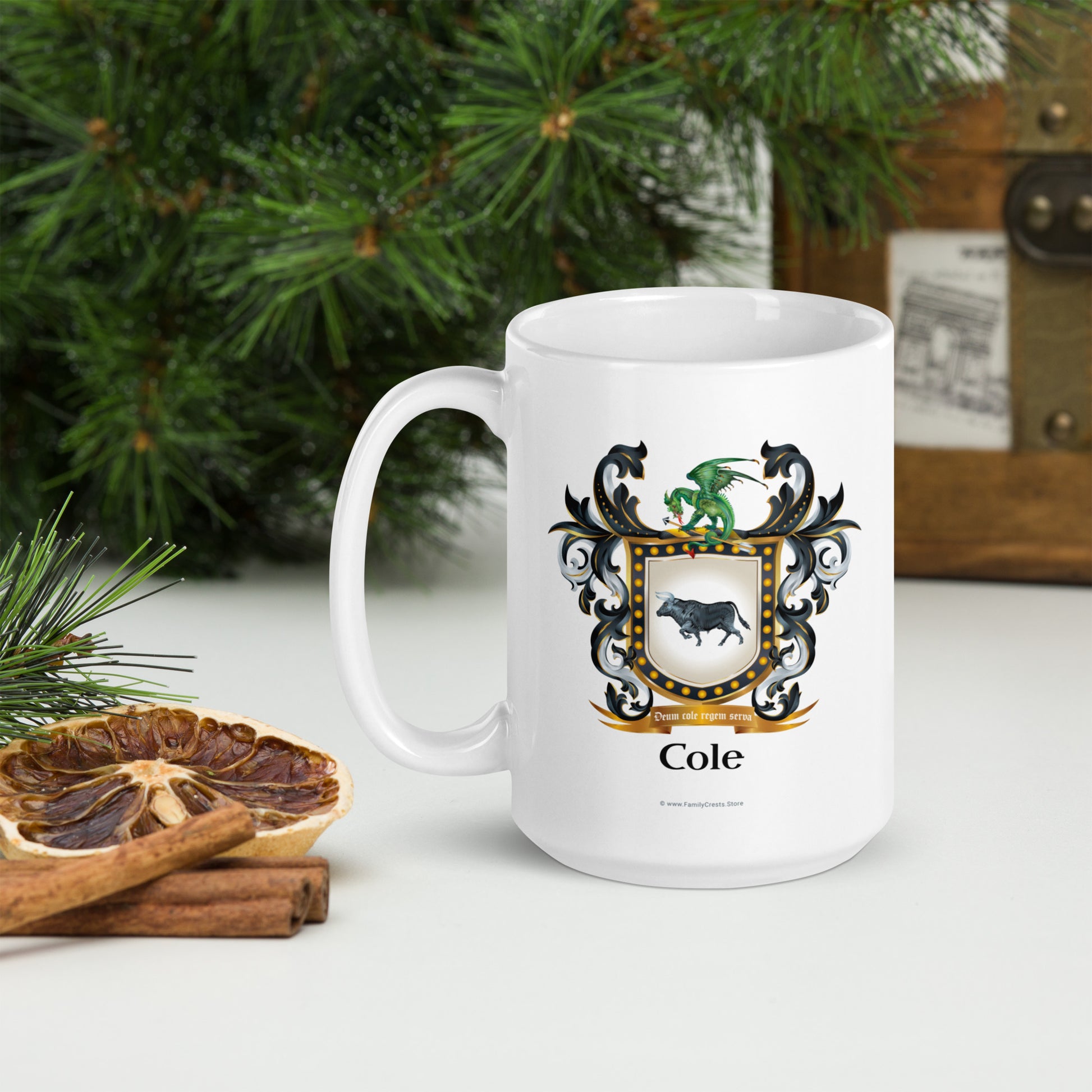 White mug with Cole family crest on a table with Christmas decorations.
