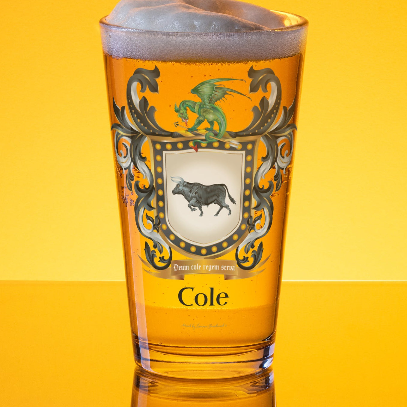 Pint of beer with a Cole family coat of arms showing a black bull and a dragon on the front of the glass on a yellow-golden background