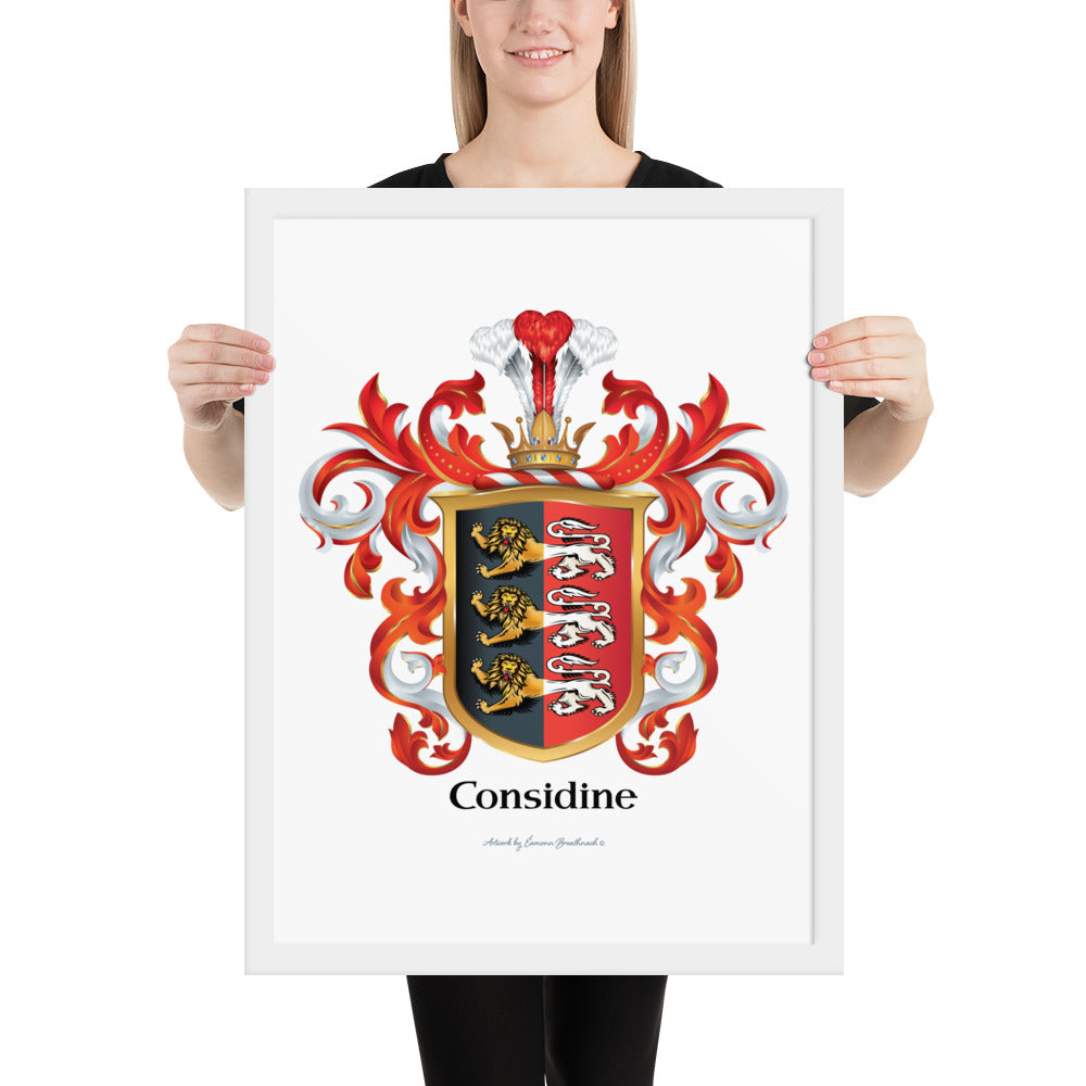 A woman holding a framed Considine Family Crest art-print with 3 lions on a shield that has a vertical colour split with black on left and red on right printed on white paper