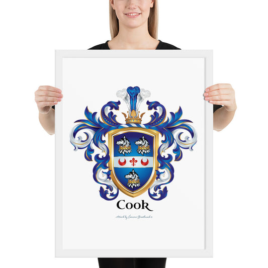 A woman standing in a white background, holding a white framed print of the Cook Family Crest featuring a blue shield with 3 wolf heads with crowns around their necks and a white band with 2 red crescents and a fleur de lis.