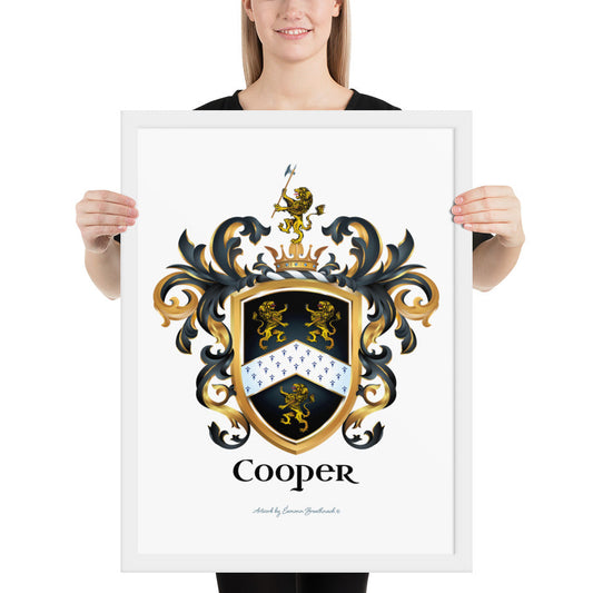 A woman standing in a white background, holding a white framed print of the Cooper family crest featuring 3 lions and a patterned chevron on a black shield.