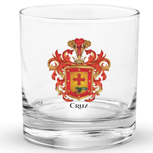A clear classic heavy base rocks glass on a white background, printed with the Cruz Family Crest 