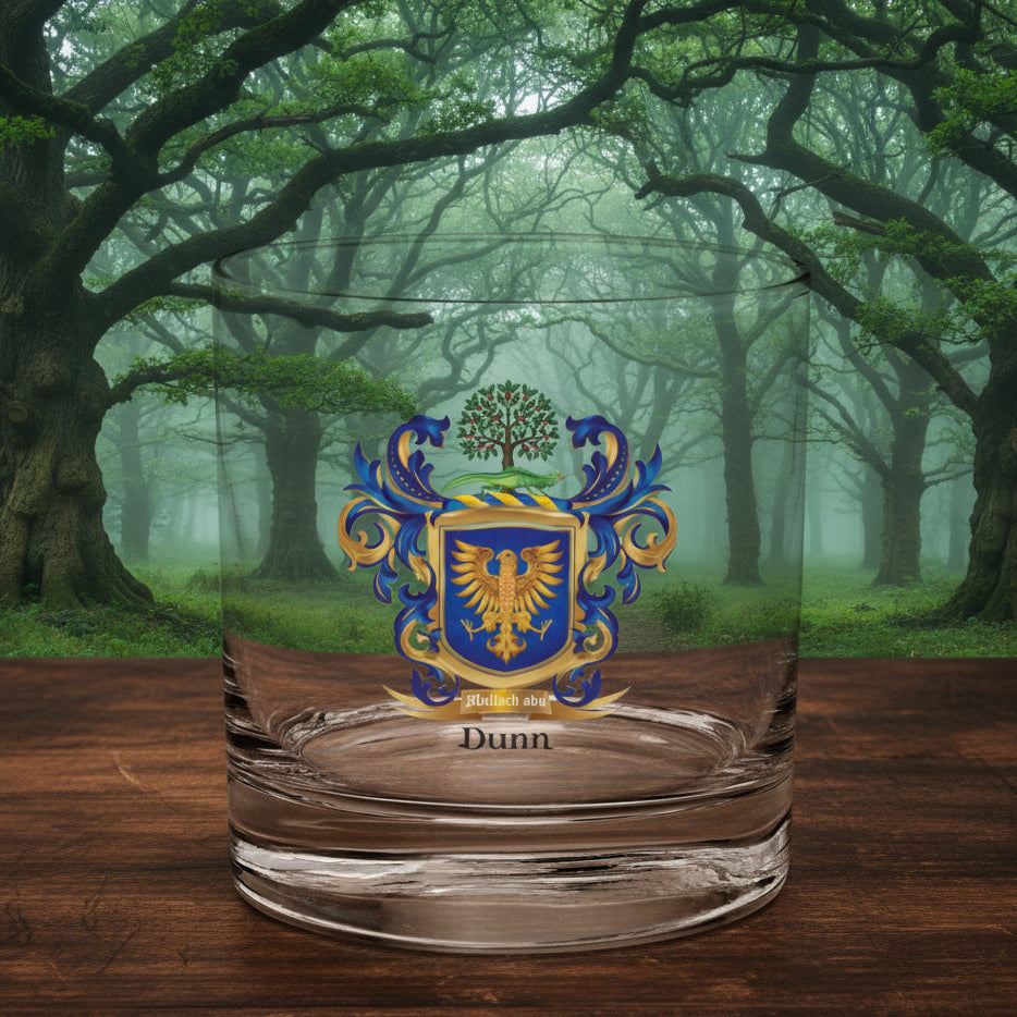 A Dunn-Family-crest-rocks-glass on a wooden table top with an irish forest landscape in the background