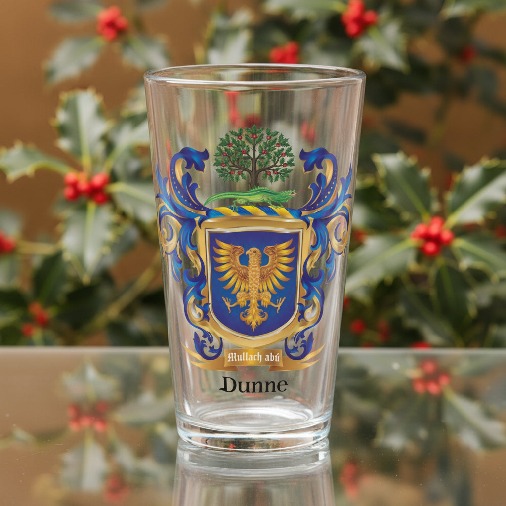 Dunne Family Crest on a pint glass with a holly tree in background
