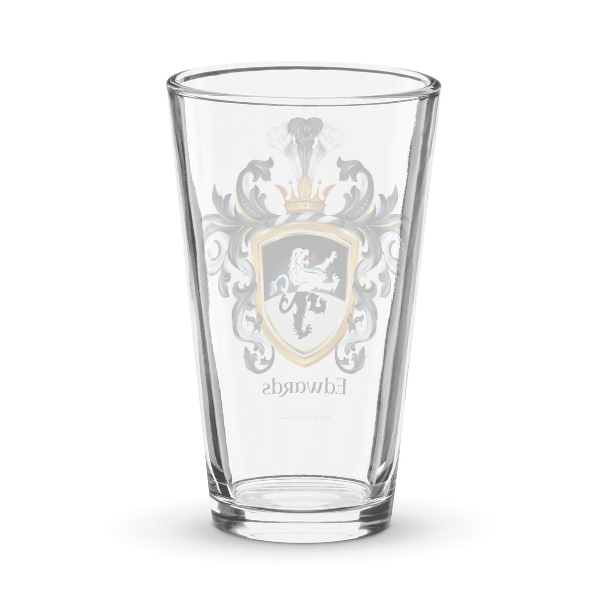A clear classic pint beer glass on a white background, printed with the Edwards Family Crest - back view of glass.
