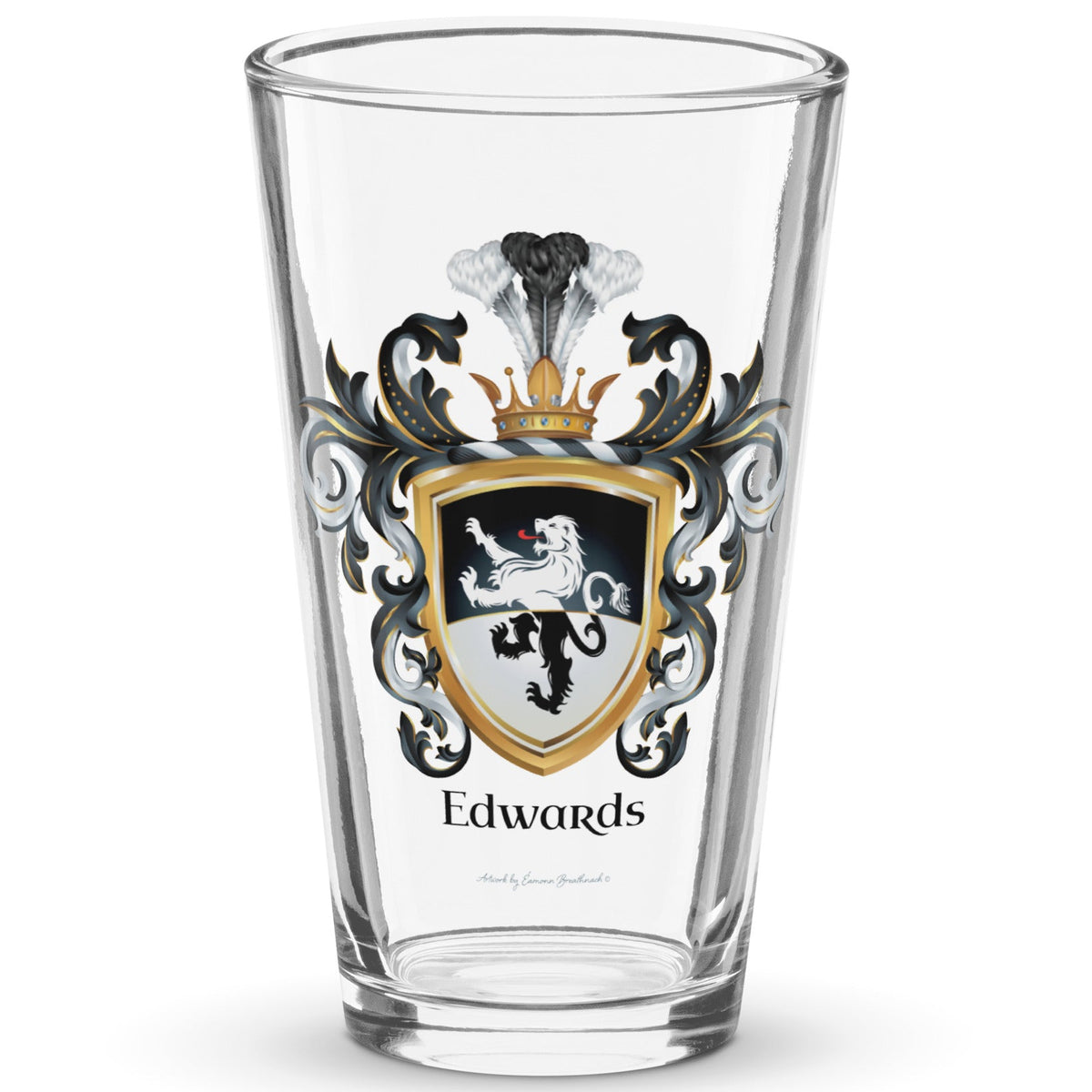 A clear classic pint beer glass on a white background, printed with the Edwards Family Crest which features a lion on a horizontally split black and white shield.