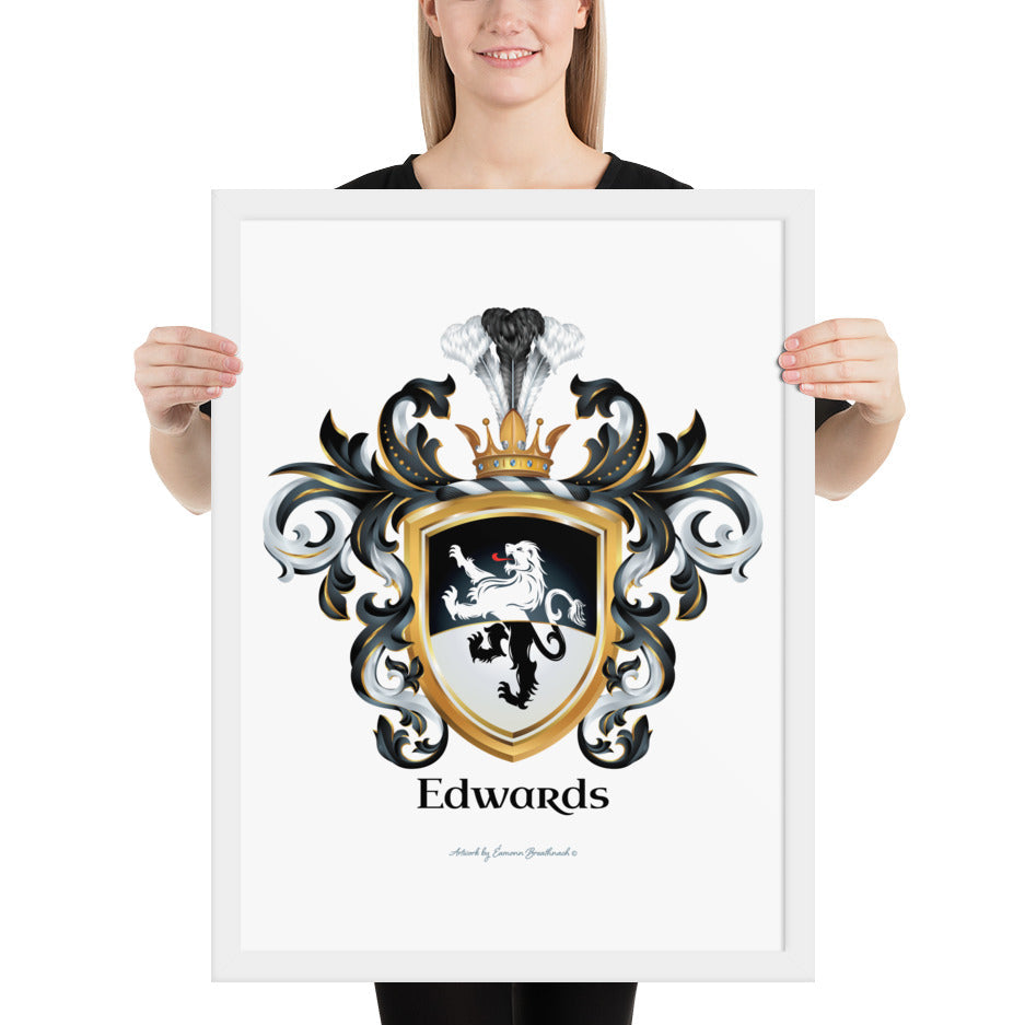 A woman standing in a white background, holding a white framed print of the Edwards Family Crest which features a lion on a horizontally split black and white shield.