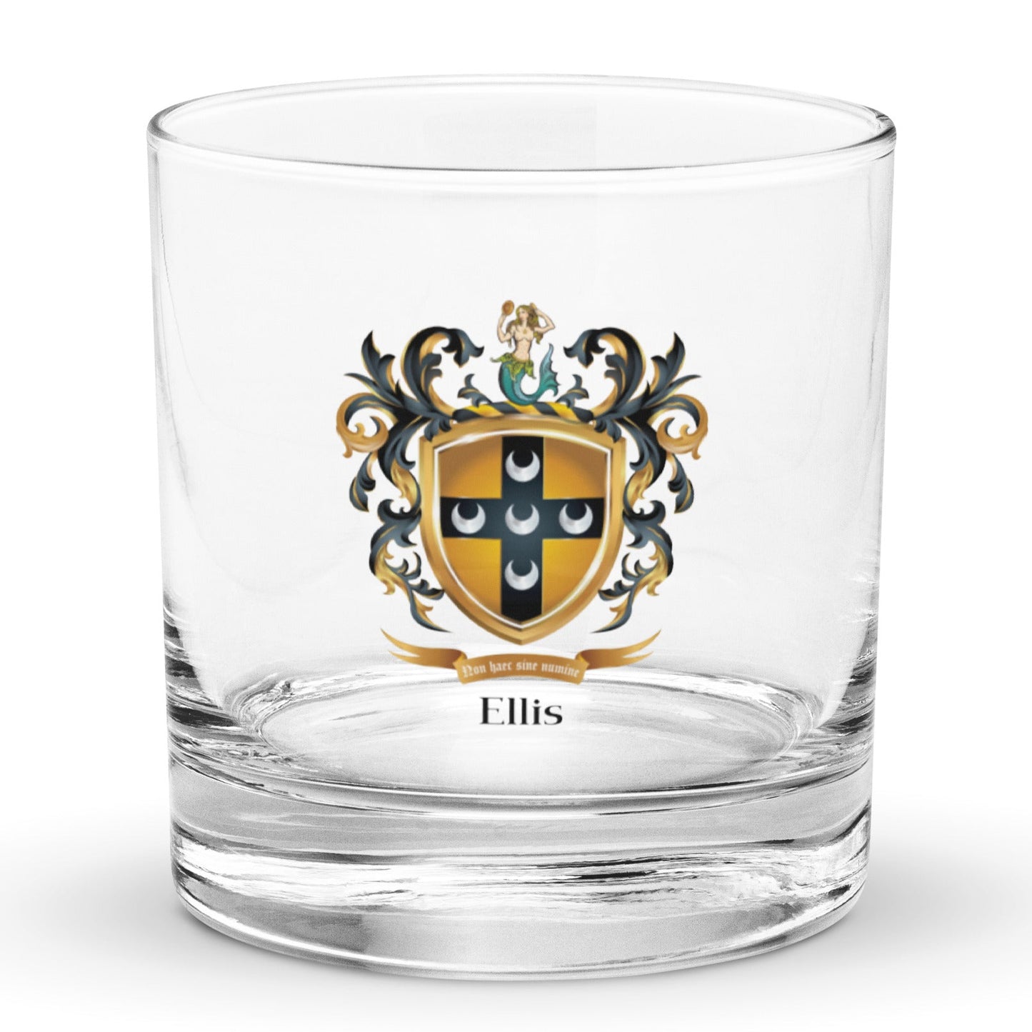 A rocks glass on a white background with the Ellis Family Crest featuring five silver crescents on a black cross on a old shield with a mermaid on the crest above the shield.