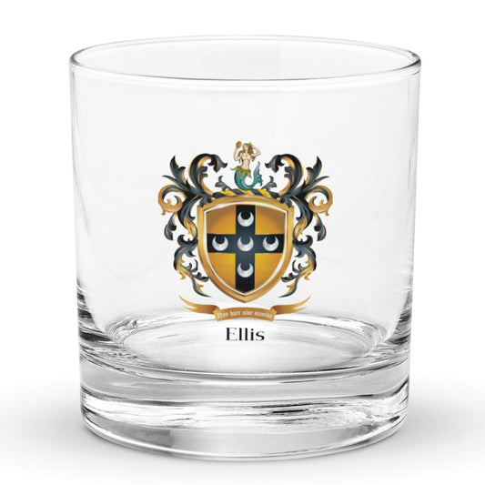 A rocks glass on a white background with the Ellis Family Crest featuring five silver crescents on a black cross on a old shield with a mermaid on the crest above the shield.