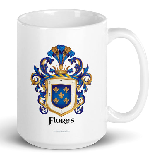 A white mug on a white background with the Flores Family Crest printed on it and the handle on the right. The coat of arms has a blue shield, 5 gold fleur-de-lis, blue and gold mantling, and the name 'Flores' in black heraldic text.