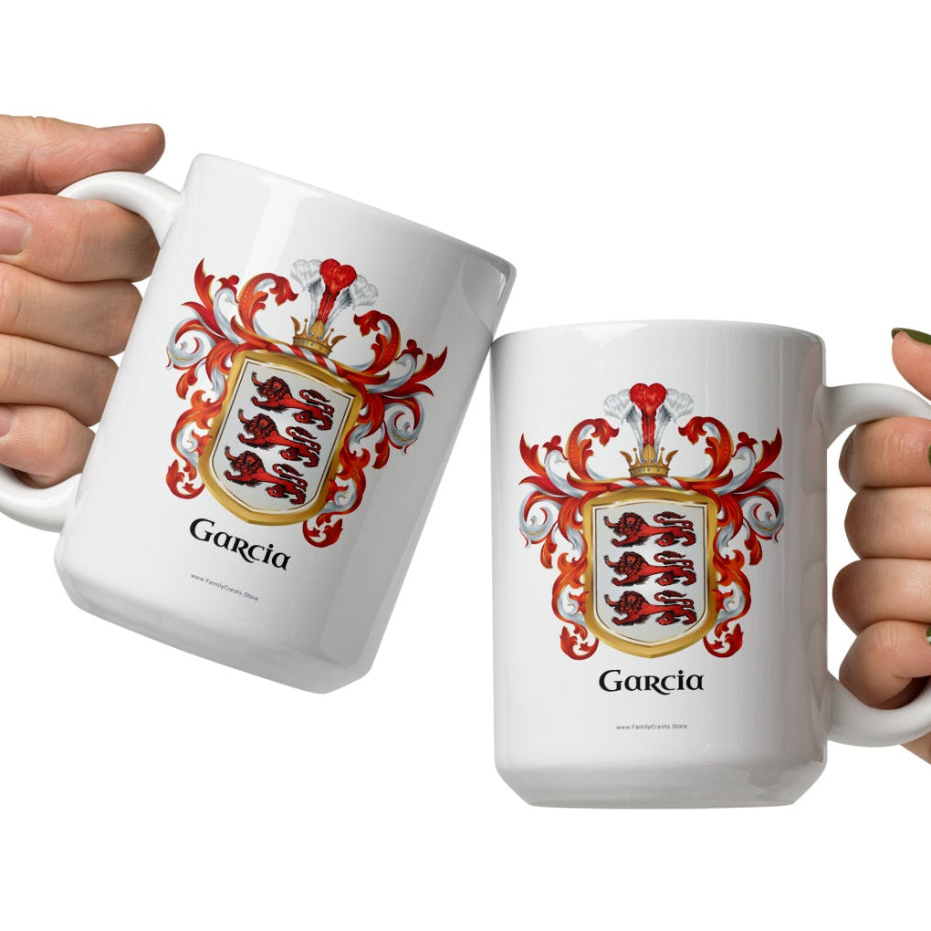 Two hands holding white Garcia family crest mugs with 3 red lions on a white shield.