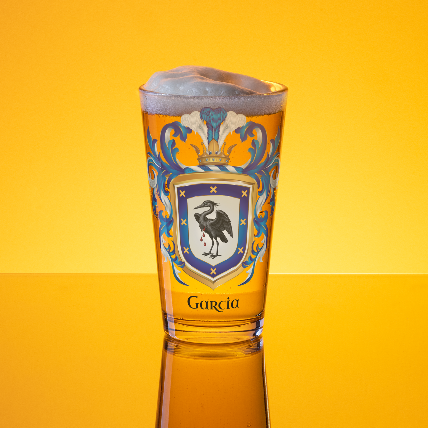 A clear beer pint glsss with a Garcia Family Crest showing a heron on a white and blue shield with the name Garcia under the coat of armour in black text on a golden lit backdrop.