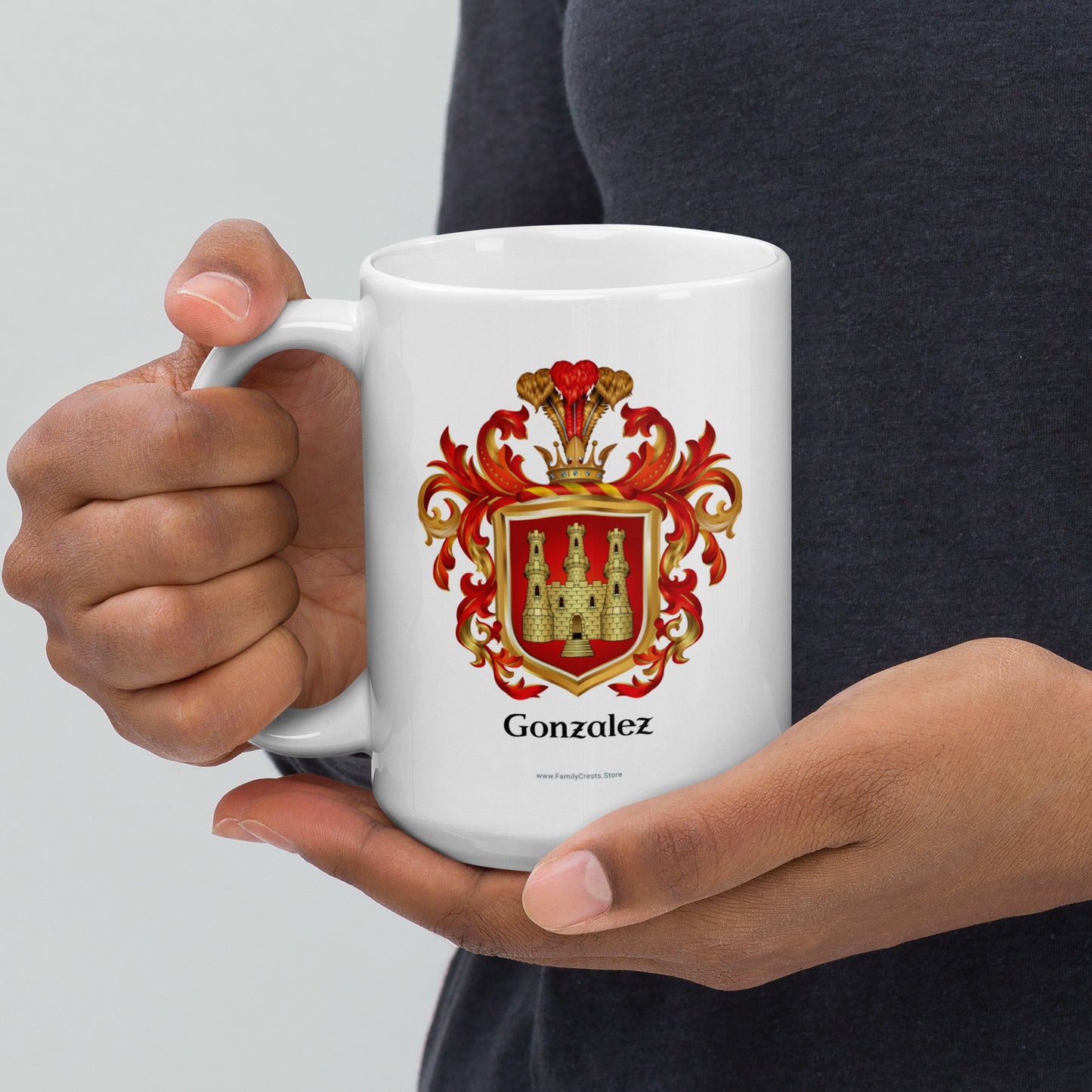 Person holding a white mug with a red and gold coat of arms design and 'Gonzalez' in black text under the red shield with a gold castle on it