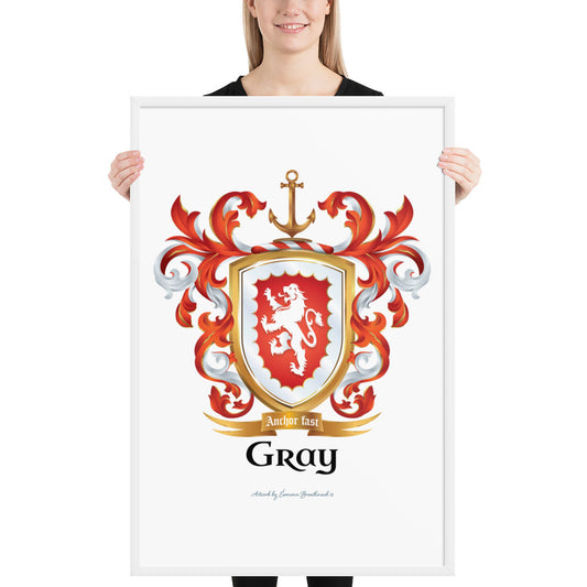 A woman standing in a white background, holding a white framed print of the Gray Family Crest featuring a red shield and white lion and a gold anchor on the crest.