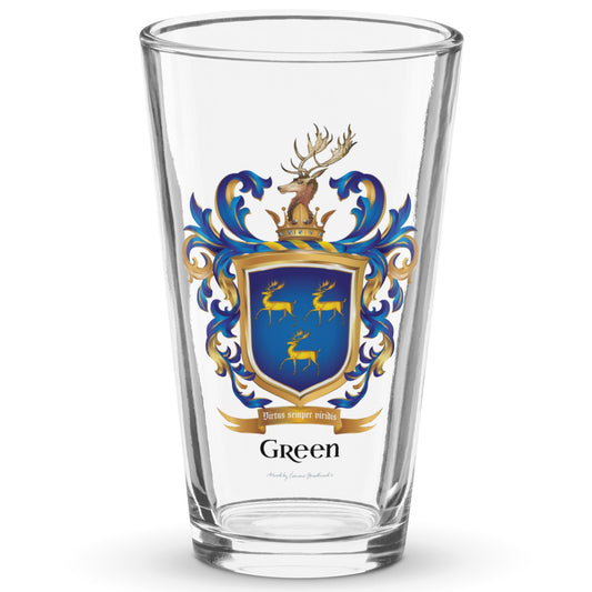 A classic clear pint beer glass on a white background with the Green Family Crest printed on the glass featuring 3 gold stags on a blue shield with a stags head on the crest above the shield.