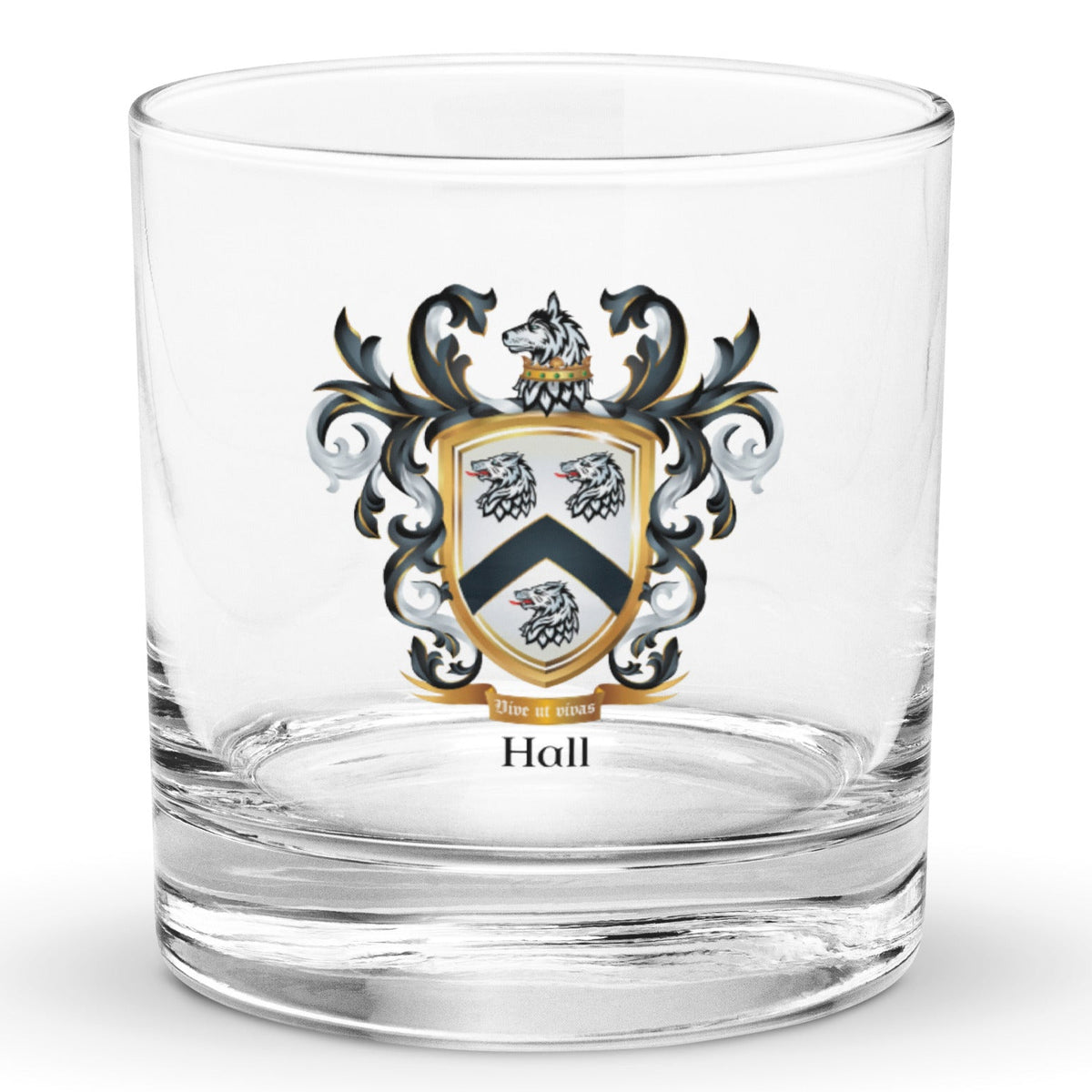 A clear classic heavy base rocks glass on a white background, printed with the Hall Family Crest. The crest features a white shield with a black chevron between three wolf heads (two above, one below), topped by wolf with a gold crown around it's neck and surrounded by detailed black and white mantling. The family name and motto appear beneath the shield.
