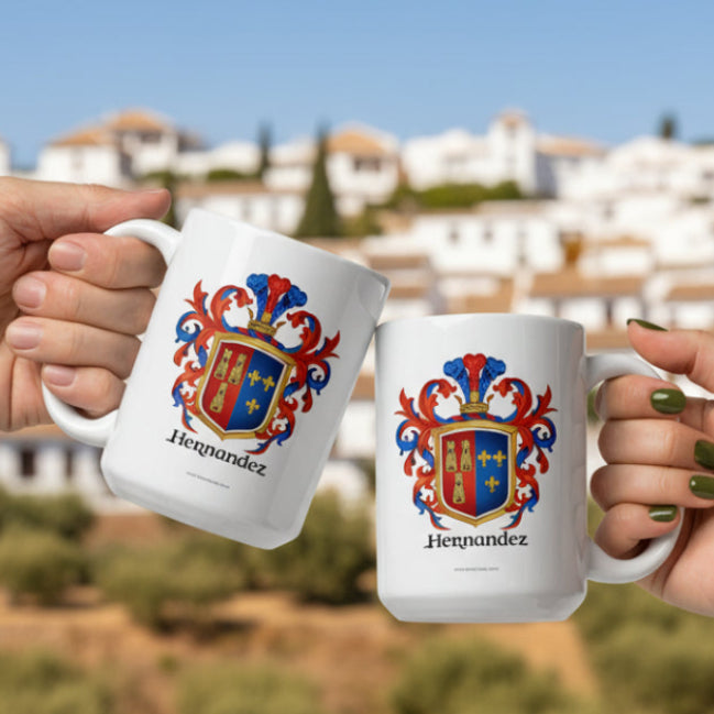 Two hands holding white mugs with colorful Hernandez family crest designs on a white background