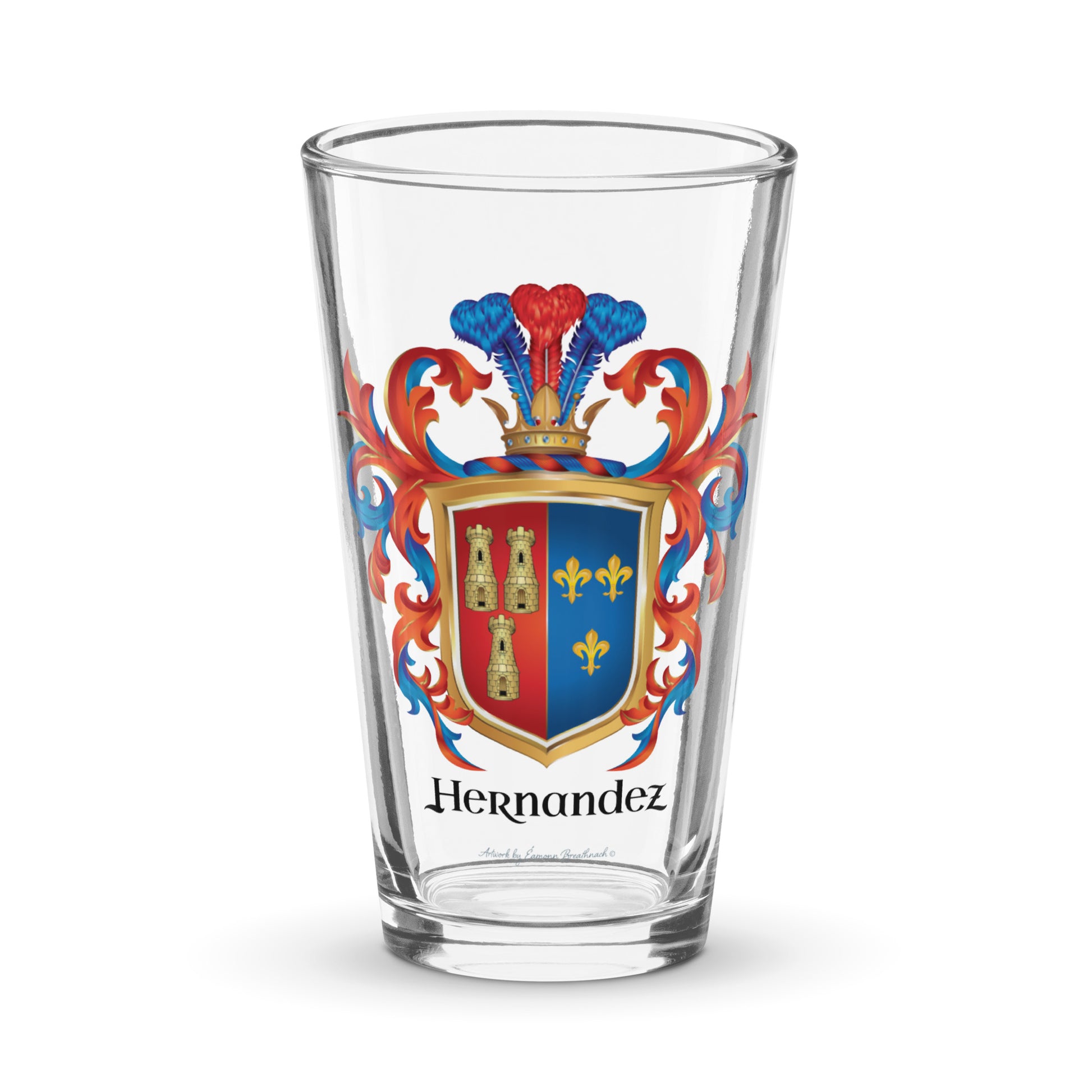 A clear pint beer glass on a white background with the Hernandez coat of arms on the front of the glass featuring a two colour shield, red on left with 3 towers, blue on right  with 3 fleurs-de-lis, and 3 plumes rising from the crown on the crest sitting on top of the shield and the name Hernandez in black slightly stylised typography all surrounded by blue and and red mantling.