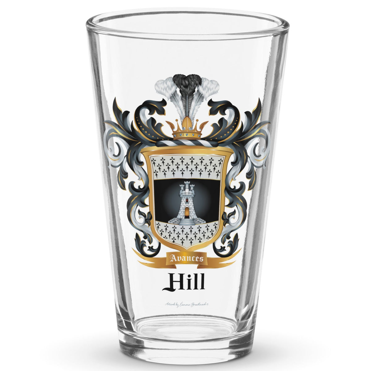 A classic clear pint beer glass standing in white space with the Hill Family Crest which features a white tower with 3 small towers on top of it on a black and white shield with ermine patterns, printed on it.