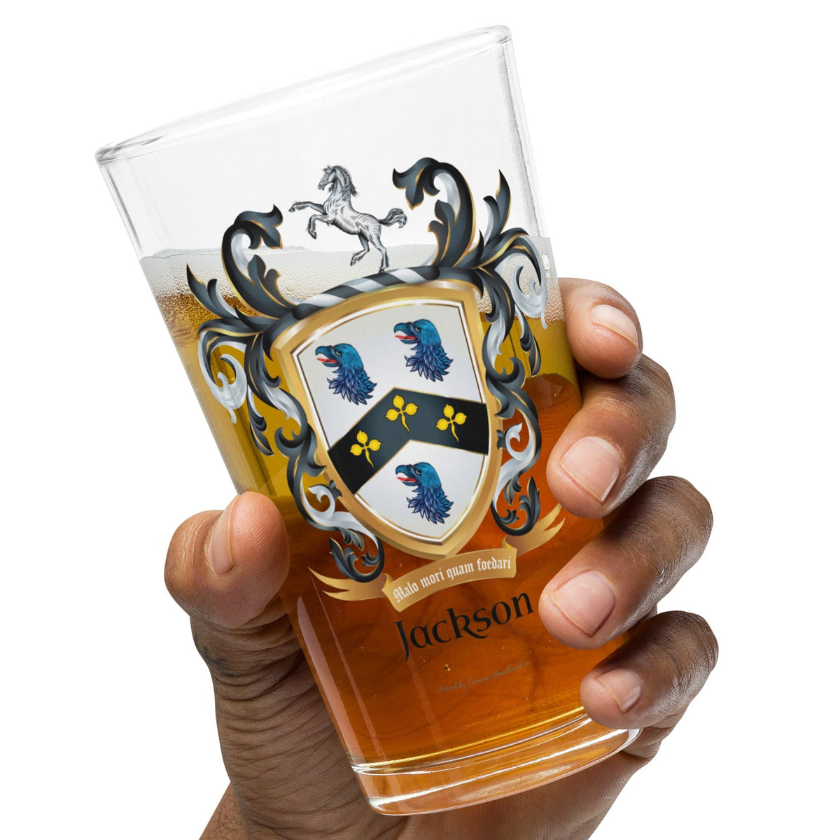 A hand holding a pint  beer glass with the Jackson Family Crest 3 blue eagle heads and a white horse