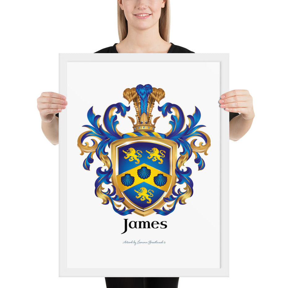 A woman standing in a white background, holding a white framed print of the James Family Crest which features a blue shield with a golden chevron containing 3 blue clam shells and two gold lions above the chevron and one beneath it.