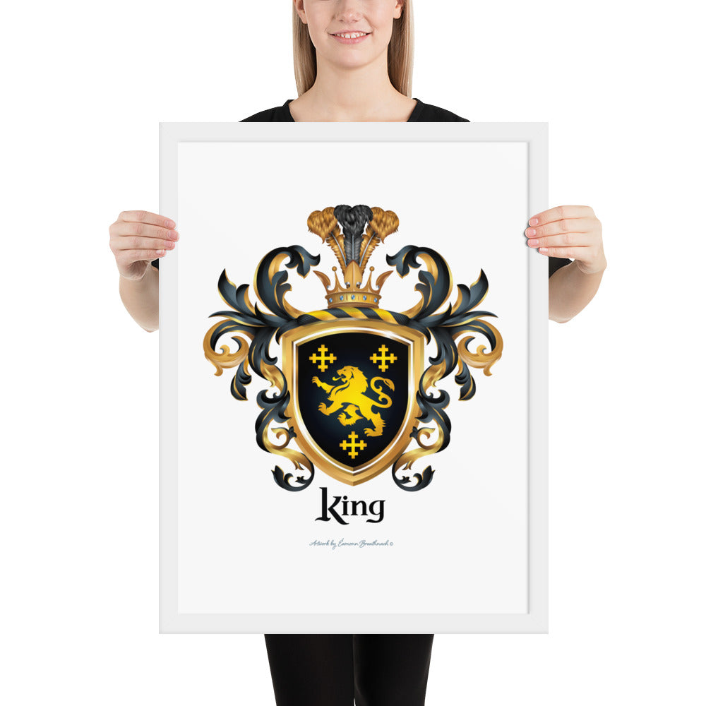 A woman holding a white framed print of the King Family Crest featuring 3 GOLD CROSSES AND A GOLD LION ON A BLACK SHIELD.