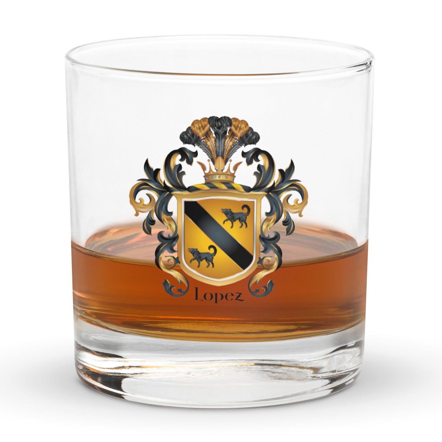 A rocks glass with whiskey with the Lopez Family Crest printed on the front of the glass featuring a gold shield with a black diagonal band and two black wolves and the name Lopez in black text below the shield.