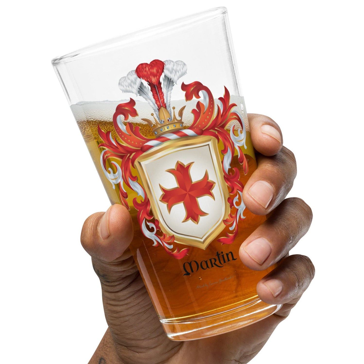 Hand holding a glass of beer with a Martin Family Crest on a white background