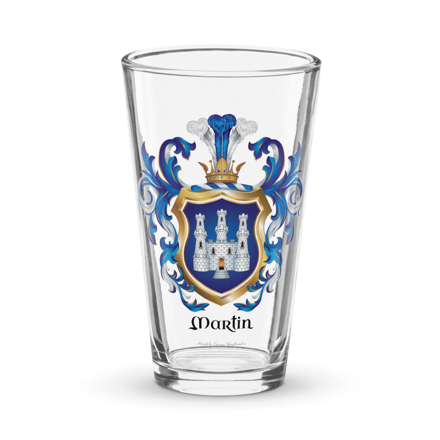 A clear pint glass featuring a personalized family crest with the name 'Martin' printed below. The crest includes a blue and gold shield with a white castle, flanked by blue mantling,