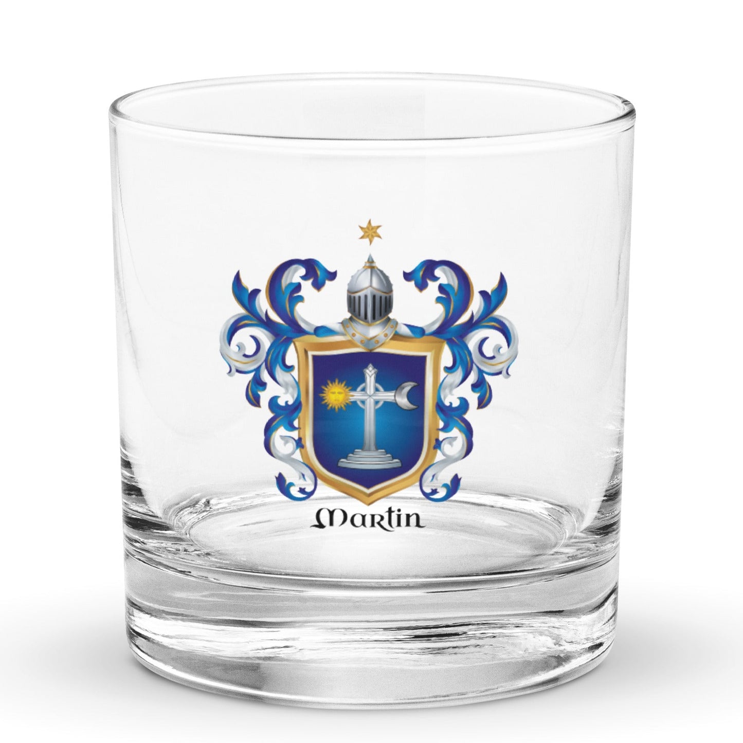 A clear glass rocks tumbler with an Irish Martin family crest printed on the front. The crest features a blue and gold shield with a white cross, blue scrollwork, and a small gold star above a helmet, with the name 'Martin' printed in black below the crest.