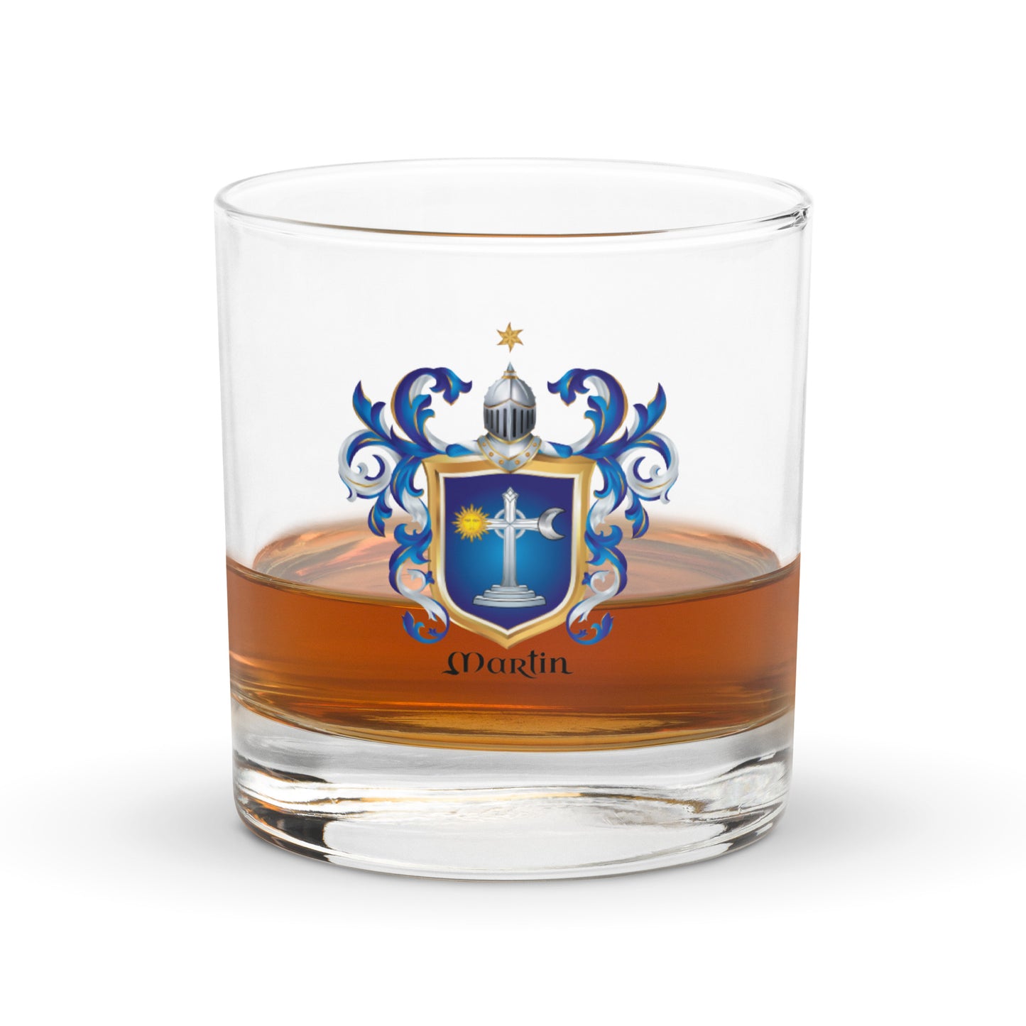 A clear rocks glass containing whiskey, featuring a Irish Martin family crest with the name 'Martin' printed below in black script. The crest includes a blue and gold shield with a white cross, blue scrollwork, and a silver helmet.