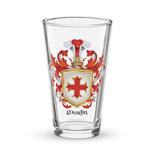 A pint glass with the Martin Family Crest featuring a red cross on a white shield 