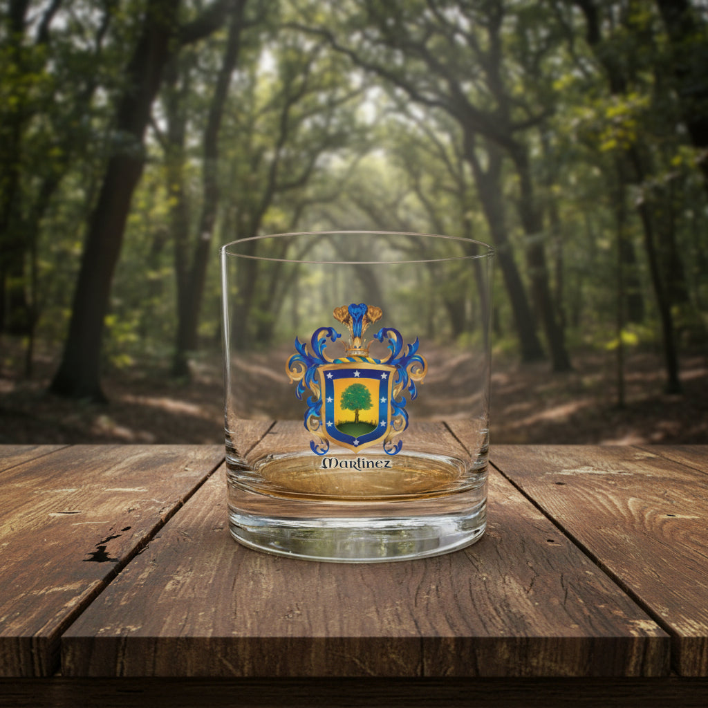 Clear glass with a family crest and 'Martinez' text on a wooden table with trees in background