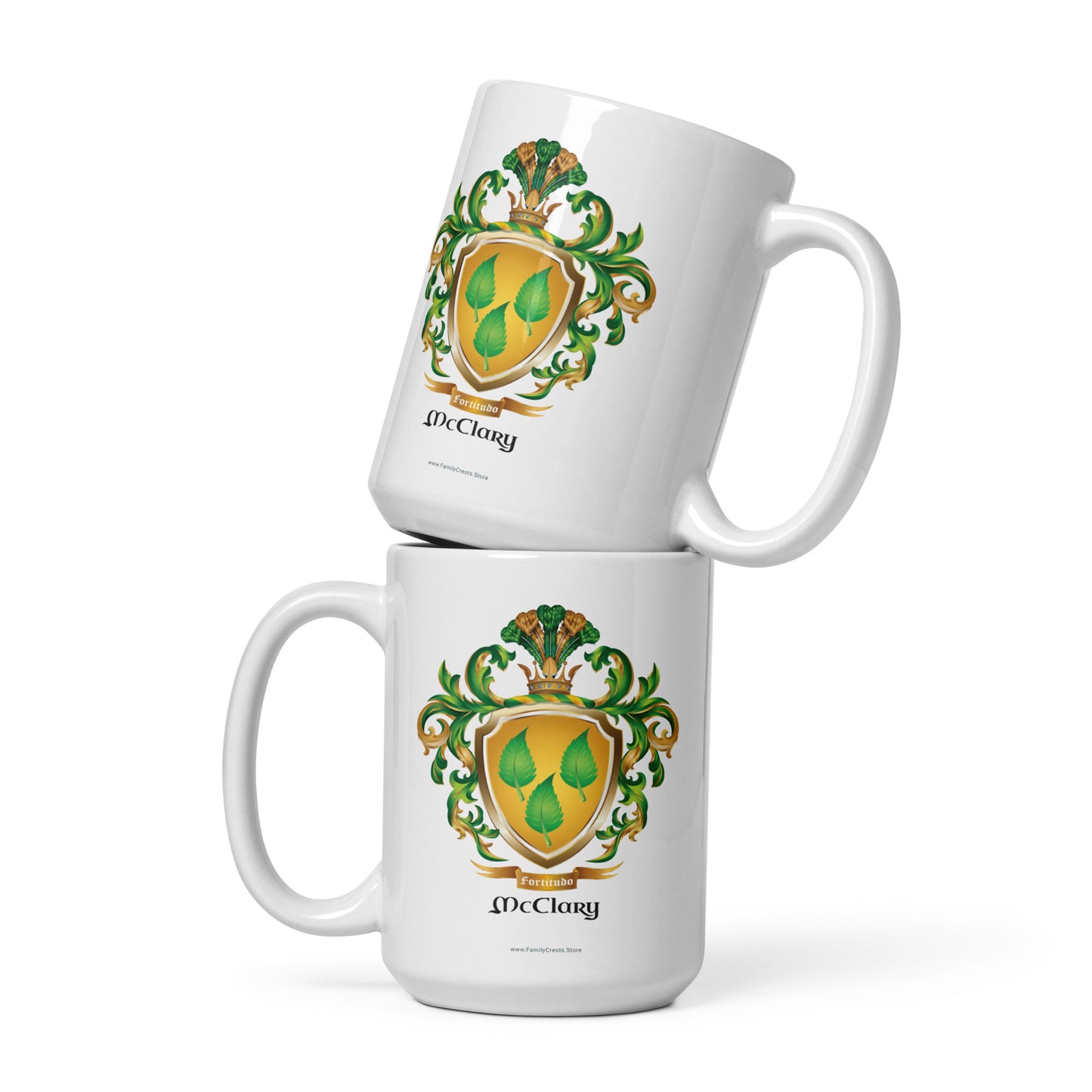 Two McClary family name coat of arms white mugs with green and gold crest design on a white background 