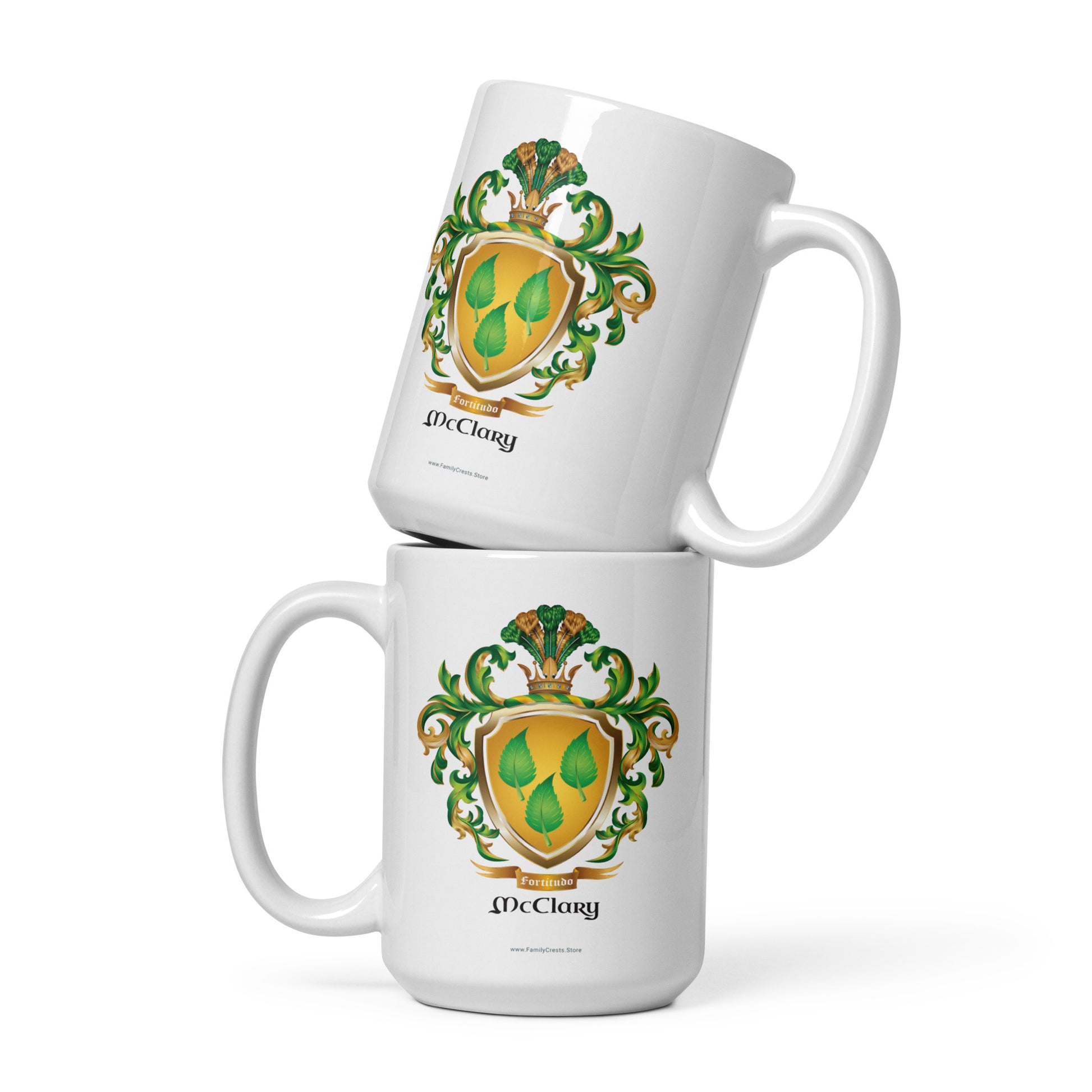 Two McClary family name coat of arms white mugs with green and gold crest design on a white background 