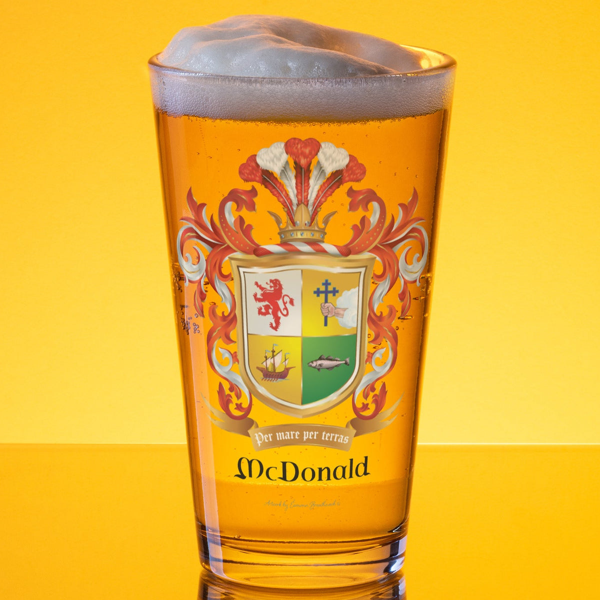 McDonald Family Crest beer glass full of beer in a gold lit background