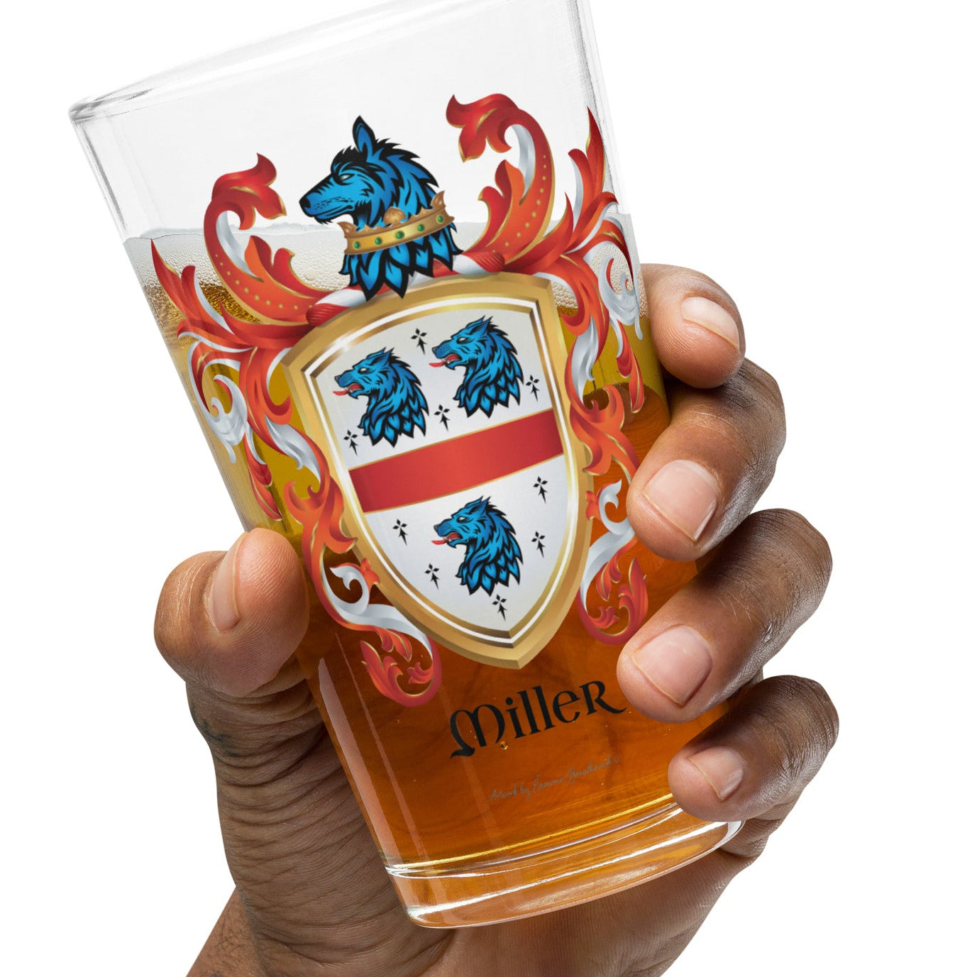 Hand holding a glass with a Miller Family Crest on a white background